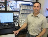 Brian Amsden in front of peptide synthesizer